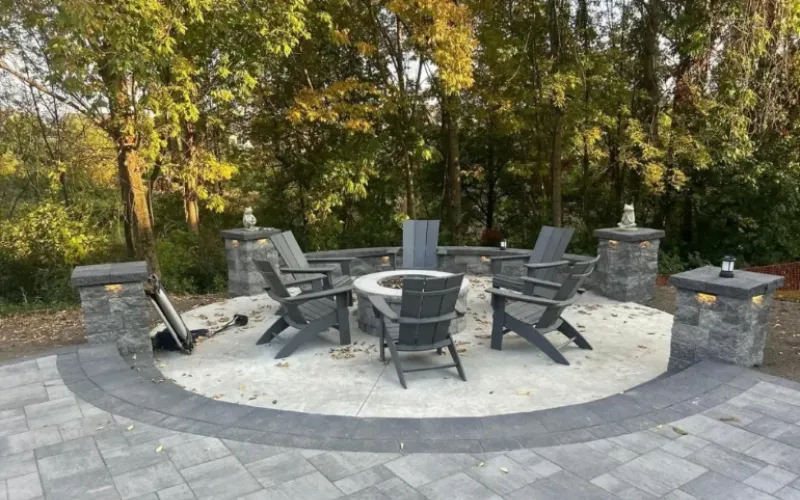 concrete fire pit with brick pavers and cultured stone pillars